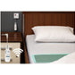 Wireless WetSense Bed Alertamat on top of fitted bed sheet next to bed side table with wall point reciever