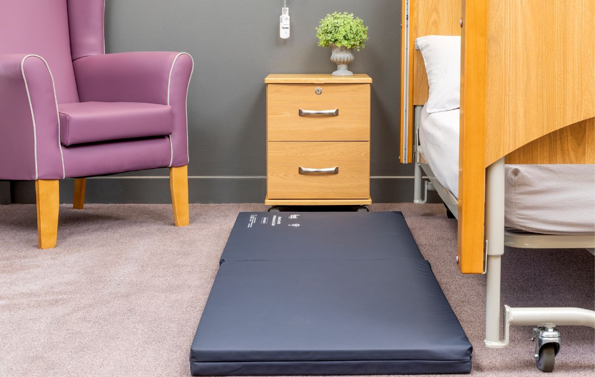 alertamat crash mat withwireless nurse call alert on carpetted flooring next to bed